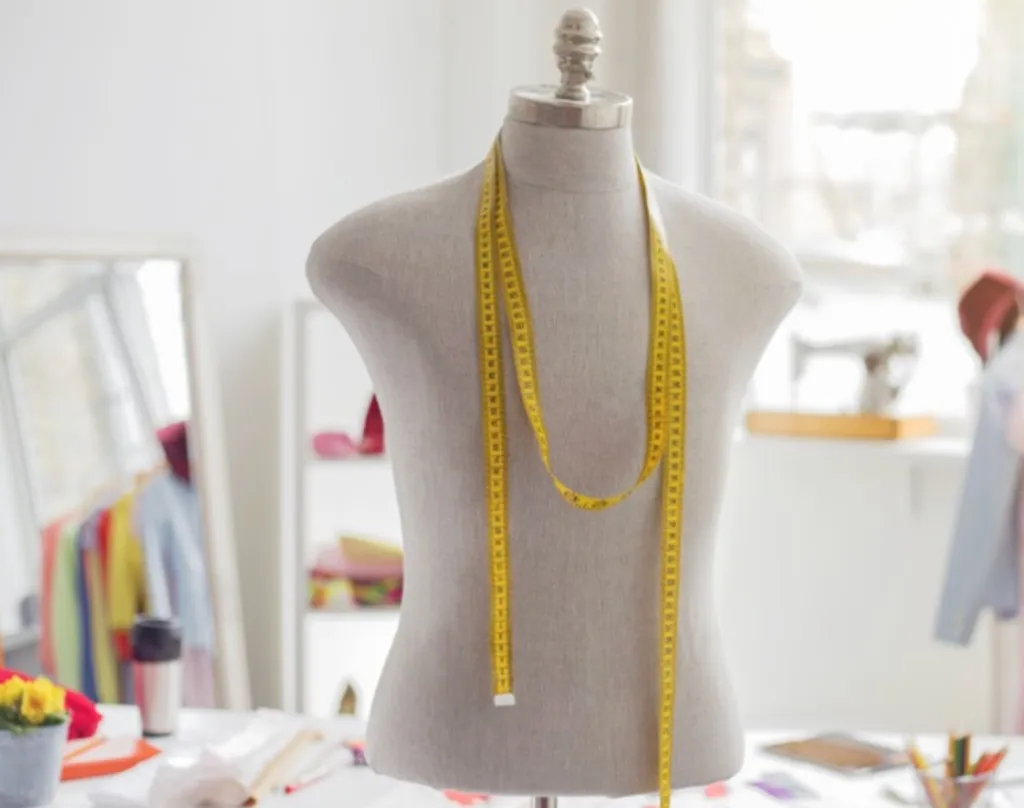 Mannequin de couture dans un atelier lumineux, mètre ruban jaune et espace de création mode professionnel